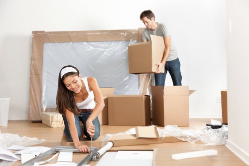 Movers in Bromley carefully handling a home relocation with boxes and furniture
